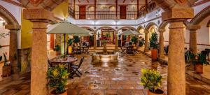 a lobby with a fountain and tables and chairs at Maria Bonita Hotel in Villa de Leyva