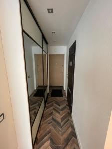 a hallway with mirrors on the walls of a room at AIVI apartments in Daugavpils