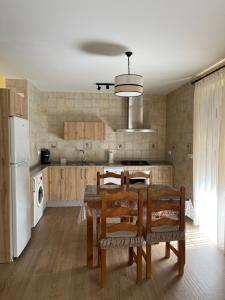 a kitchen with a table and chairs and a refrigerator at Casa Rural De Mascoras in Santibáñez el Alto