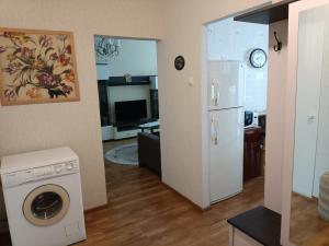 a kitchen and living room with a washer and a refrigerator at Welcome home Taikos 72V-22 in Visaginas