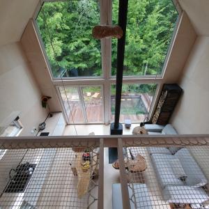 an attic view of a room with a large window at Schody do wody Domek z linią brzegową Kaszuby sauna goraca balia 