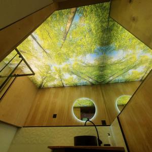 a room with a ceiling with a painting of trees at Schody do wody Domek z linią brzegową Kaszuby sauna goraca balia 