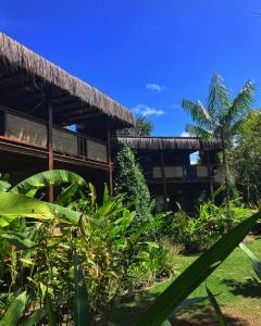 a building with a bunch of plants in front of it at Boa Village- Bungalow com Piscina Natural- Praia de Algodões in Marau