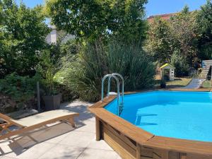 a swimming pool in a yard with a bench next to it at Albi centre ville -piscine view our profile please in Albi