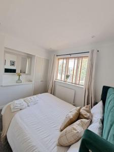 a bedroom with a white bed with a window at Beachwood House, Serviced Accommodation in Brumby