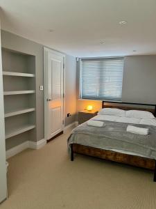 ein Schlafzimmer mit einem großen Bett und einem Fenster in der Unterkunft A luxury brand-new apartment in Barnet