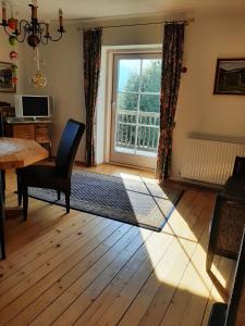 a living room with a table and a window at Ferienwohnung im alten Zollhaus in Dellach