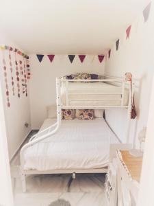 a bedroom with two bunk beds with flags on the wall at Moraleja, habitación en bajos con jardín en Estepona in Estepona