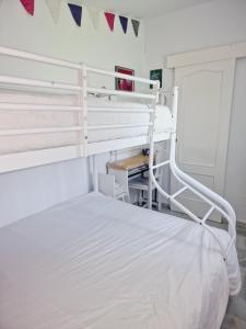 a bedroom with two bunk beds and flags on the wall at Moraleja, habitación en bajos con jardín en Estepona in Estepona