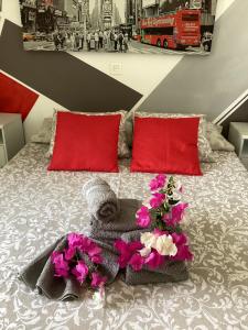 a bedroom with a bed with flowers and red pillows at ROXY HOME in Puerto del Carmen