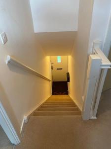 a hallway with a stairway leading up to a building at Contemporary Coach House in Newport, Isle of Wight in Newport