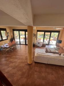 a large living room with a couch and a table at Country Vila in Nikiti