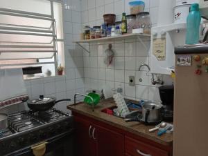 a kitchen with a sink and a stove top oven at Casa para temporada - Campos do Jordão in Campos do Jordão