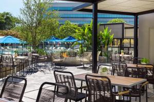 an outdoor patio with tables and chairs and a fire pit at Renaissance Walnut Creek Hotel in Walnut Creek