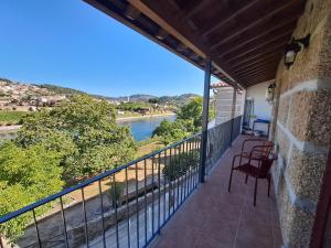 a balcony with a view of a river at Burguesinha AL Entre-os-Rios in Entre-os-Rios