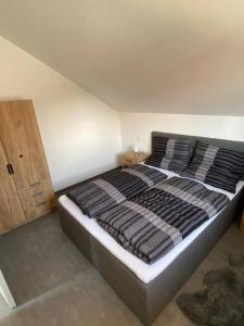 ein großes Bett in einem Zimmer mit einem Holzschrank in der Unterkunft Ferienwohnung Valentin in Passau