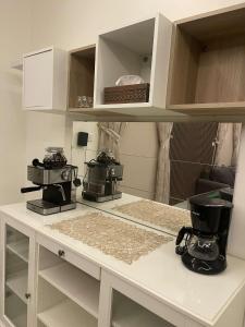 a kitchen with a counter with three appliances on it at شقه فاخرة بالنرجس بالقرب من المطار in Riyadh