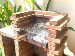 a brick barbecue grill with a grille on it at Courtyard living w/ BBQ garden in secluded hamlet in Uluwatu