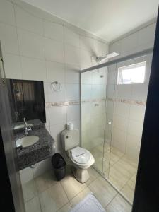 e bagno con servizi igienici, lavandino e doccia. di Shallom Hotel a Balneário Camboriú