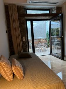 a bedroom with a bed with a view of the ocean at Olympus Stone Lodge in Litochoro