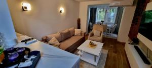 a living room with a couch and a table at The Modern Lodge in Skopje
