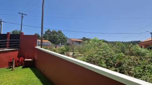 a garden on the side of a house at Vila Henrique Country Cottage in Fajã da Ovelha