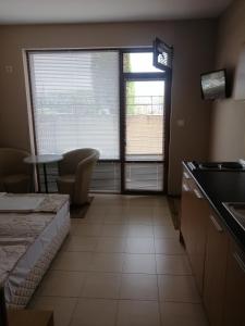 a room with a kitchen with a window and a table at Villa Vega in Sozopol