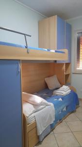 a bedroom with two bunk beds with blue walls at La Villetta di Leonardo, con piscina privata in Campofelice di Roccella