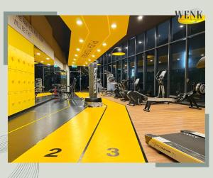 a gym with treadmills and machines in it at Neu Suites @ 3RdNvenue A in Kuala Lumpur