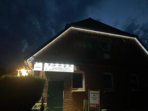 a sign on the side of a house at night at Altenmedinger Hof in Altenmedingen