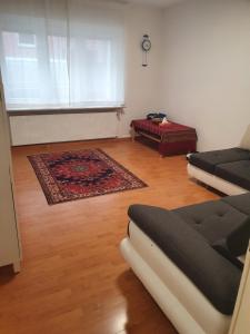 a living room with a couch and a rug at Nice apartment Düsseldorf Derendorf in Düsseldorf