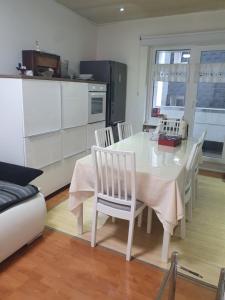 a kitchen with a white table and chairs in a room at Nice apartment Düsseldorf Derendorf in Düsseldorf