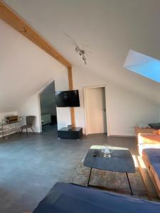 a living room with a couch and a tv at Dachterrassenwohnung Alois in Passau