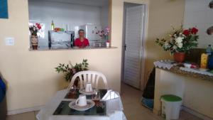 a kitchen with a table and a woman in a mirror at Hotel Porto da Lua Belém in Belém