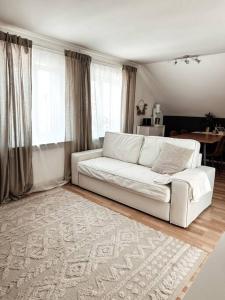 a living room with a white couch and a table at Stilvolle Wohnung im Allgäu in Kempten
