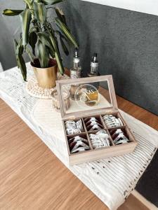 a table with a box of chocolates and a plant at Stilvolle Wohnung im Allgäu in Kempten