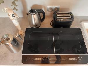 a kitchen counter with a stove top with a toaster at Modernes Apartment “Traum“ in Mehlmeisel