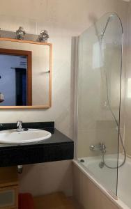 a bathroom with a sink and a shower at Sea&Harbour Puerto del Carmen in Puerto del Carmen