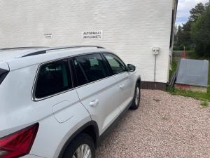 a white car parked in front of a building at Holiday Home Sodankylä in Sodankylä