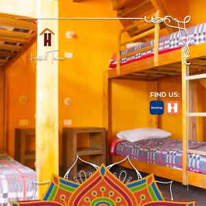 a room with two bunk beds and a sign that reads find us at Hostal Café Tiana in Latacunga