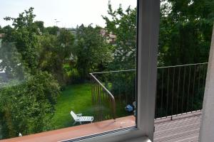 a view from a window of a balcony with a bench at Przytulne duże mieszkanie w domku jednorodzinnym in Koszalin
