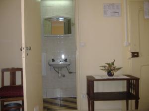 a small bathroom with a toilet and a sink at Residência Ideal in Coimbra