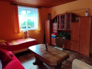 a living room with a couch and a table at Ralsko Hradčany 2 in Hradčany
