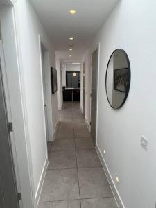 a hallway with a mirror and a tile floor at Stunning Luxury in Central Alderley Edge in Alderley Edge