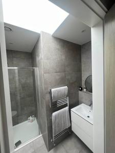 a bathroom with a shower and a sink at Stunning Luxury in Central Alderley Edge in Alderley Edge