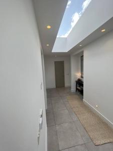 a living room with a skylight and a ceiling at Stunning Luxury in Central Alderley Edge in Alderley Edge