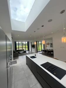 a large kitchen with a white counter in a room at Stunning Luxury in Central Alderley Edge in Alderley Edge