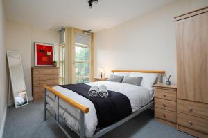 a bedroom with a large bed and a window at Brimmond Homes - nr to Univ, Hospitals, o2 Apollo, PLAB & 7 mins to City Centre - Stylish, Modern & Secure 2 Bed, 2 Bath Apt with Allocated Free Parking in Manchester