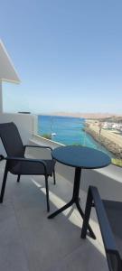 a patio with two tables and a view of the ocean at Sabbia Suites Varadero in Puerto del Carmen