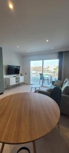 a living room with a wooden table and a couch at Sabbia Suites Varadero in Puerto del Carmen